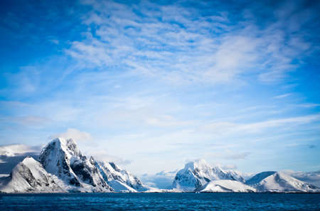 Beautiful snow-capped mountains against the blue skyの写真素材