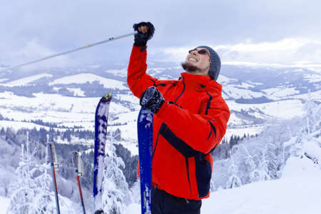 Man on top of mountain holding arms upの写真素材
