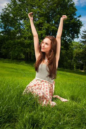 Girl in a grove looking in the skyの写真素材
