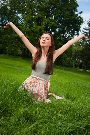 Girl in a grove looking in the skyの写真素材