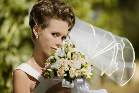 portrait of a happy bride holding flowersの写真素材