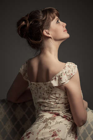girl sitting on the retro sofaの写真素材