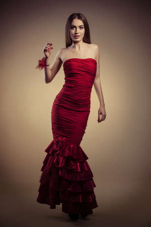 portrait of a beautiful girl in red dressの写真素材