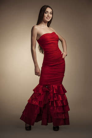 portrait of a beautiful girl in red dressの写真素材