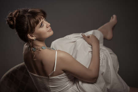 girl sitting on the retro sofaの写真素材