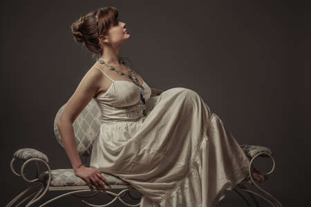 girl sitting on the retro sofaの写真素材