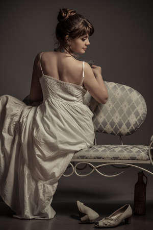 girl sitting on the retro sofaの写真素材