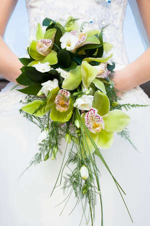 bride holding a bouquet of flowers on her wedding dayの写真素材