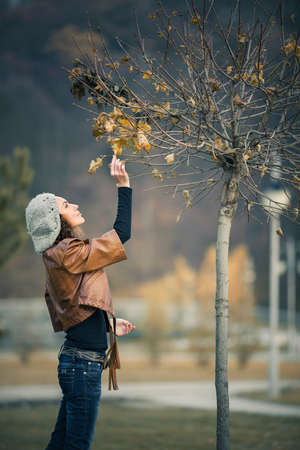 young girl in autumn parkの写真素材