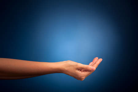 Hands holding on blue backgroundの写真素材