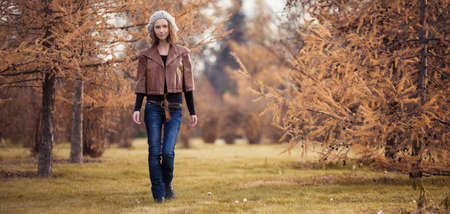 young girl in autumn parkの写真素材