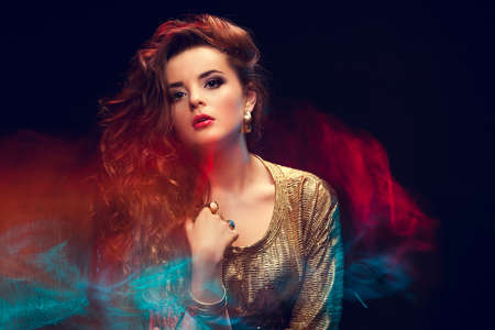 Mixed light fashion portrait of young attractive womanの写真素材