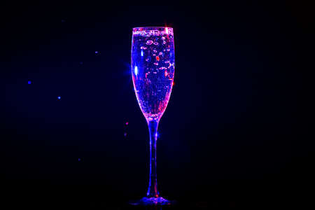 Champagne pouring in glass on a black backgroundの写真素材