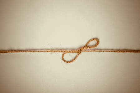 Closeup of braided twine tied in a bow knotの写真素材