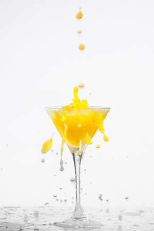 Orange cocktail with splashes on a white backgroundの写真素材