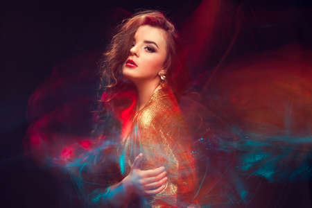 Mixed light fashion portrait of young attractive womanの写真素材