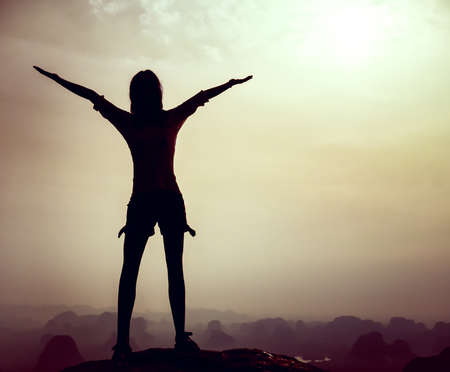Woman on top of mountain. Conceptual designの写真素材