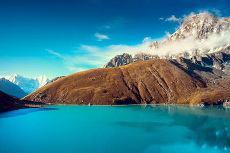 Beautiful snow-capped mountains with lake against the blue sky  Himalaya, Nepalの写真素材