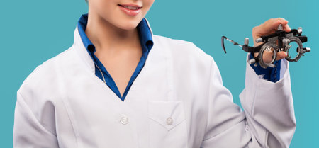 Friendly female doctor - isolated over a blue backgroundの写真素材