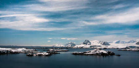 Beautiful snow-capped mountains against the blue sky in Antarcticaの写真素材