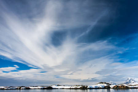 Beautiful snow-capped mountains against the blue sky in Antarcticaの写真素材