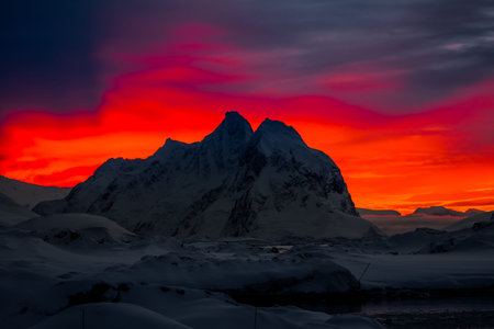 Beautiful snow-capped mountains against the sunset sky in Antarcticaの写真素材