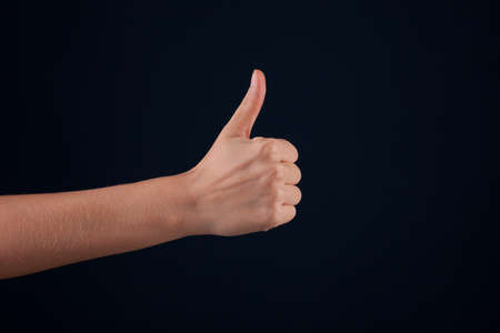 Female woman hand  on the dark backgroundの写真素材