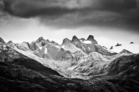 Beautiful snow-capped mountains against the white fog in Antarcticaの写真素材