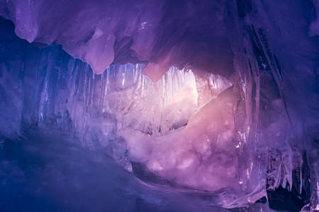 Violet ice cave covered with snow and flooded with light. Antarctica. Vernadsky Research Base.の写真素材