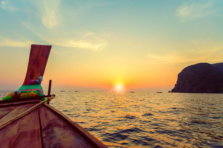 Traditional wooden boat in a tropical bay on Koh Phi Phi Island, Thailand, Asiaの写真素材