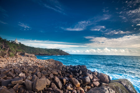 Beautiful seascape. Sea and rock at the sunset. Nature composition.