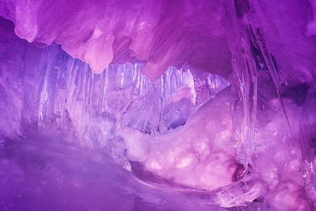 Violet ice cave covered with snow and flooded with light. Antarctica. Vernadsky Research Base.の写真素材