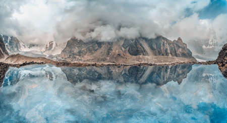 Beautiful mountain lake with reflection under the cloudsの写真素材