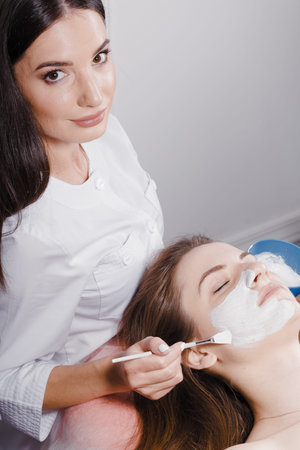 Beautiful woman with facial mask at beauty salon. Top viewの写真素材