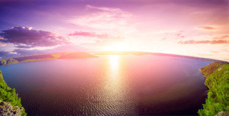 Beautiful bright sunset over the lake in mountainsの写真素材