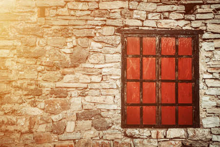 Old window in a brick wall, closed metal shuttersの写真素材