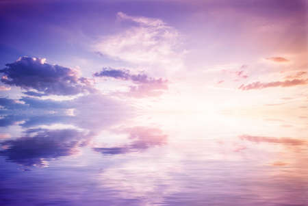 Abstract reflection in water. Reflected purple sky with clouds and sunsetの写真素材