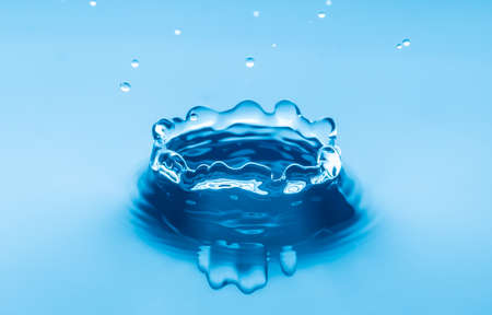 Close up abstract water drops splash on blue backgroundの写真素材