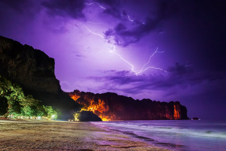 Lightning flashes across the night sky on beach in Thailand, Krabi province