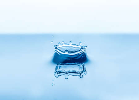 Close up abstract water drops splash on blue backgroundの写真素材