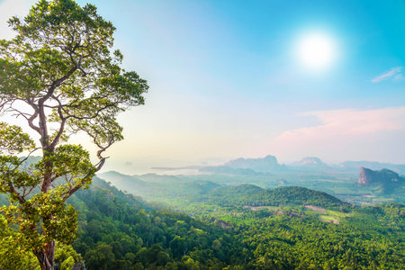 beautiful landscape with green mountains and colorful sky under sunshine in Thailandの写真素材