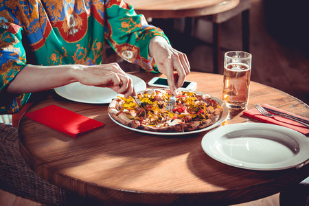 Beautiful Woman eating at a restaurant close upの写真素材