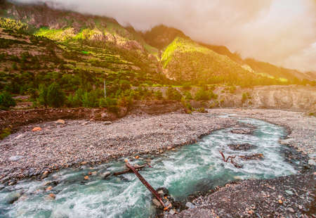 Beautiful mountain river in stone valley and cloudy sky in Nepal. Annapurna trekkingの写真素材