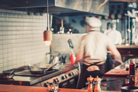 Blurred restaurant interior with salt and pepper on tableの写真素材