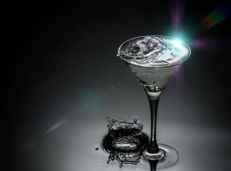 closeup of water drops falling in the glassの写真素材