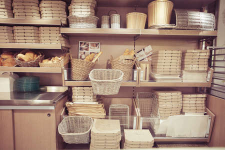 Bread in baskets. Pizza delivery boxes on shelves. Modern restaurant Interior designの写真素材