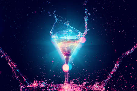 Colourful cocktail in glass with splash on the dark backgroundの写真素材
