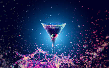Colourful cocktail in glass with splash on the dark backgroundの写真素材
