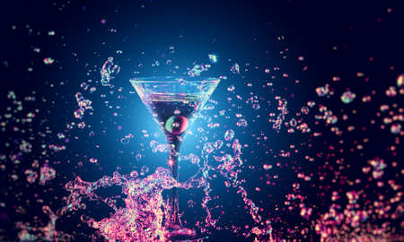 Colourful cocktail in glass with splash on the dark backgroundの写真素材
