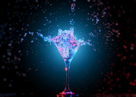 Colourful cocktail in glass with splash on the dark backgroundの写真素材